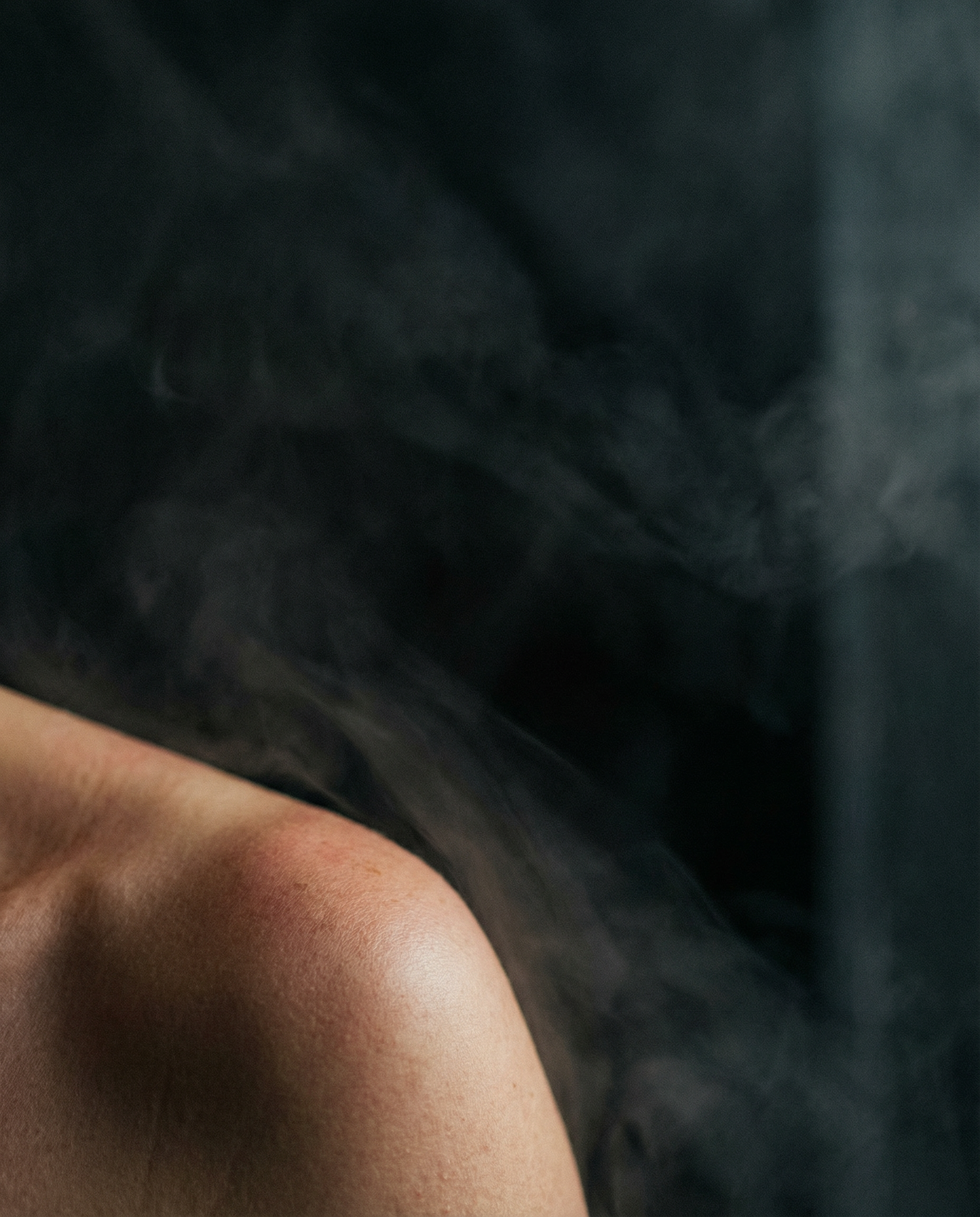 Female and a male in a hot tub wearing Saunelle sauna Hat